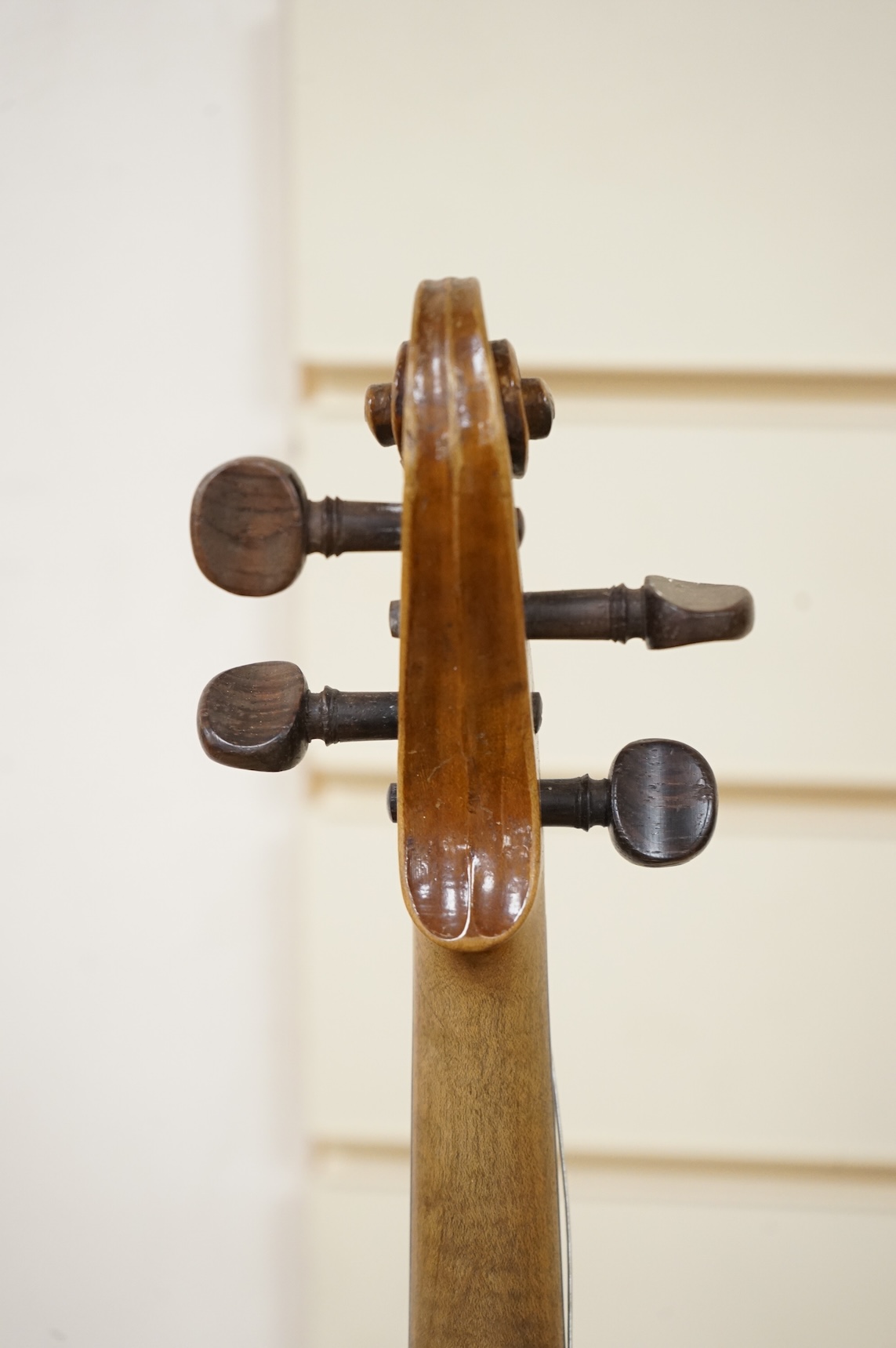Five cased 20th century violins, including; a German violin, two Czech violins, a three-quarter size violin with a label for Bienfait, and a Romanian quarter size violin, all in cases or the remains of cases.